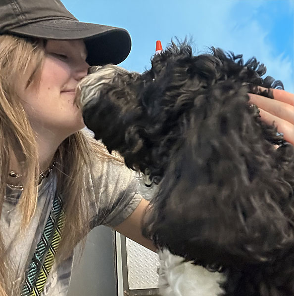 Woman face to face with a puppy